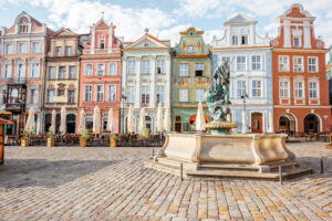 View on the beautiful old buildings with Neptune fountain on the Maket square in Poznan city during the morning light in Poland