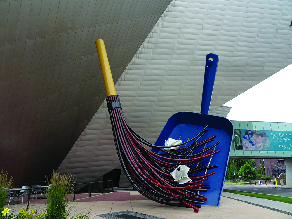 Photo of a sculpture of a broom and dustpan titled Big Sweep
