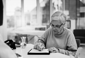 black and white photo of a woman completing prework for an interview