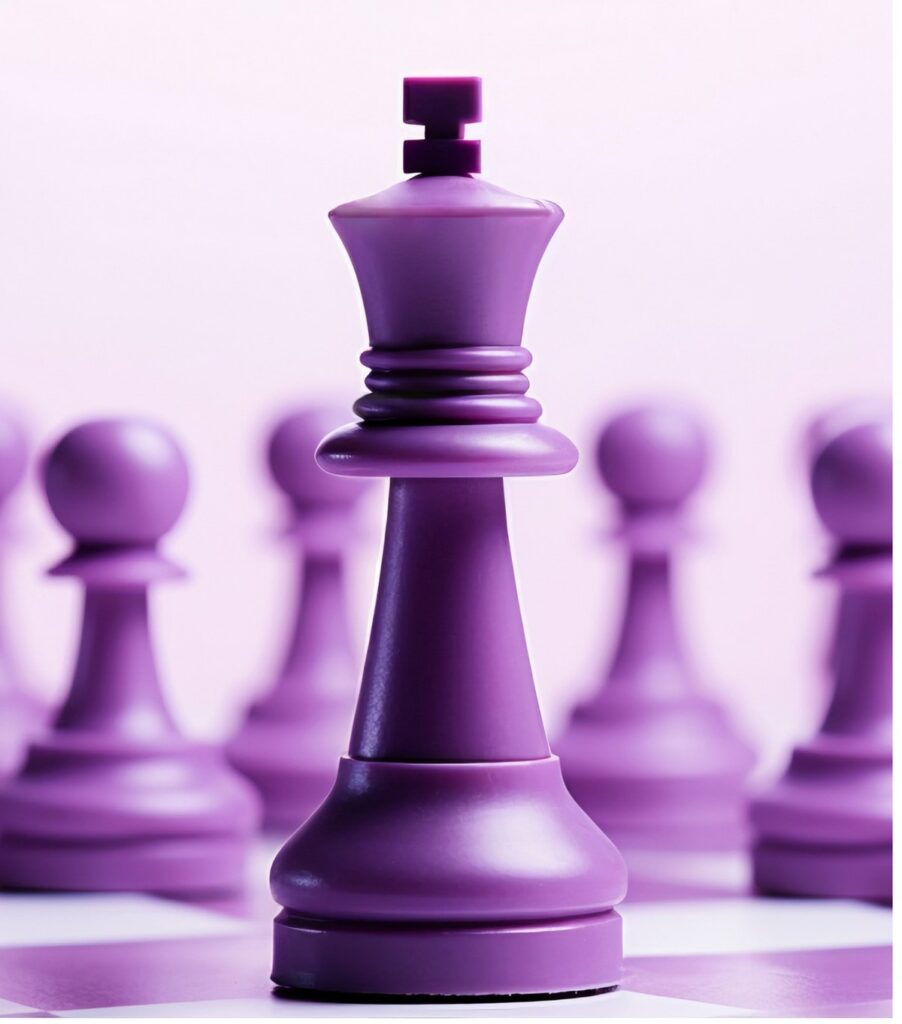 A purple chess king stands in sharp focus in front of a row of blurred pawns.